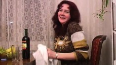 Cute redhead drinks a bottle of wine and then drops all her clothes