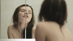 Delightful teen with a fabulous ass masturbates in front of the mirror